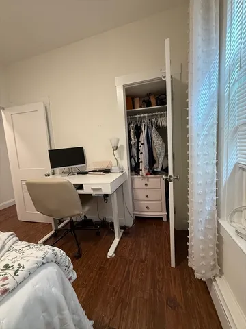 a view of a bedroom with workspace and bedroom