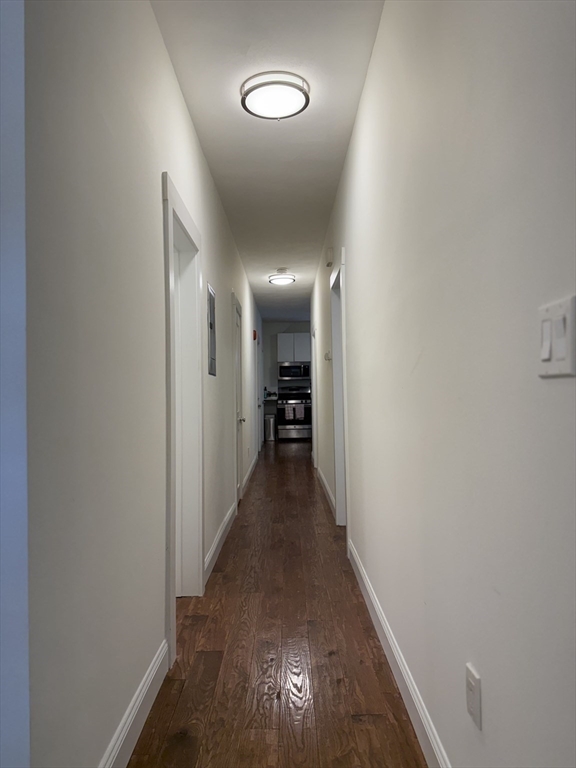 229 Charles Street, Unit 1 Cambridge, MA 02141 - Photo 6 of 19 a view of a hallway with wooden floor