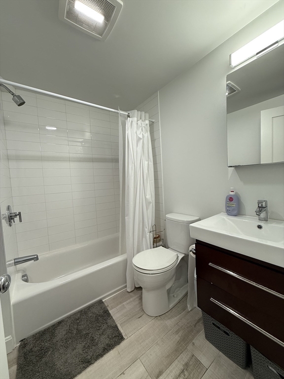 229 Charles Street, Unit 1 Cambridge, MA 02141 - Photo 7 of 19 a bathroom with a sink toilet and shower