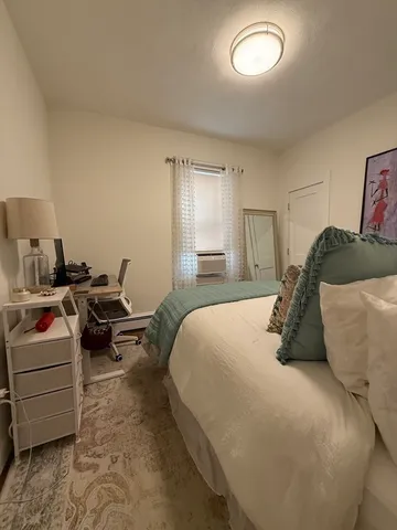 a bedroom with a bed and a couch