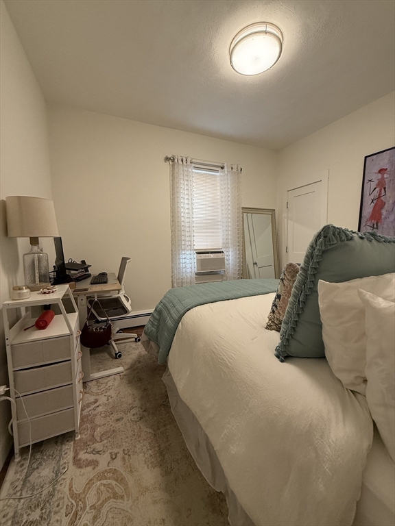 229 Charles Street, Unit 1 Cambridge, MA 02141 - Photo 8 of 19 a bedroom with a bed and a couch