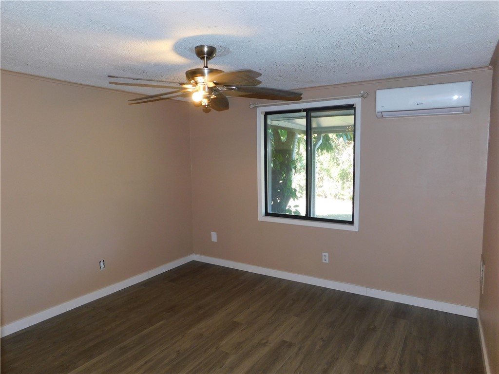 532 7th Place, Unit 532 Vero Beach, FL 32962 - Photo 3 of 8 a view of a livingroom with a ceiling fan window and hardwood floor