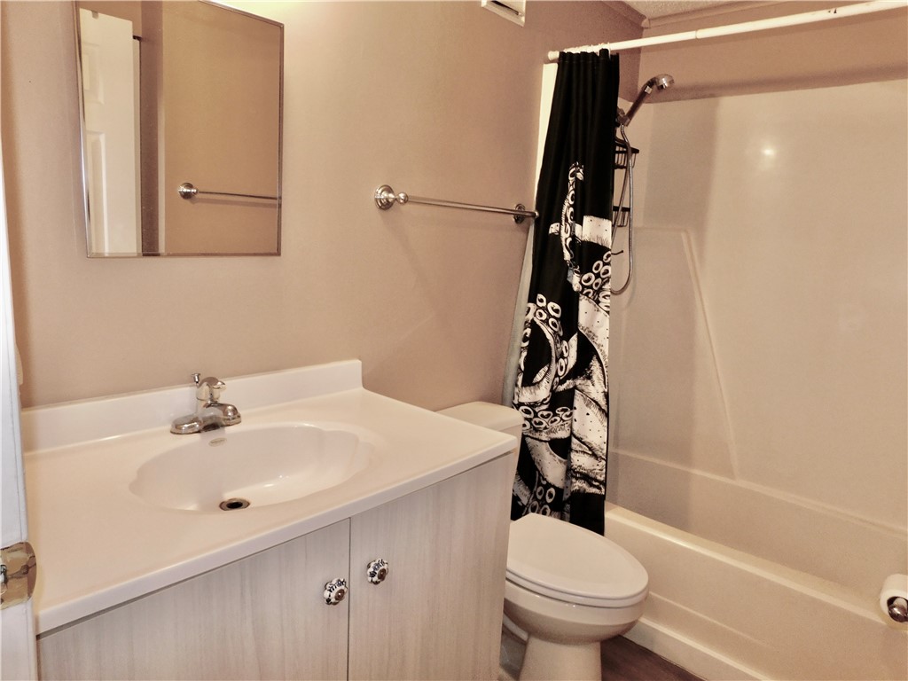 532 7th Place, Unit 532 Vero Beach, FL 32962 - Photo 7 of 8 a bathroom with a sink toilet and shower