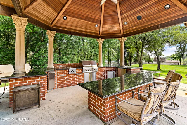 a view of pool with lawn chairs and large trees
