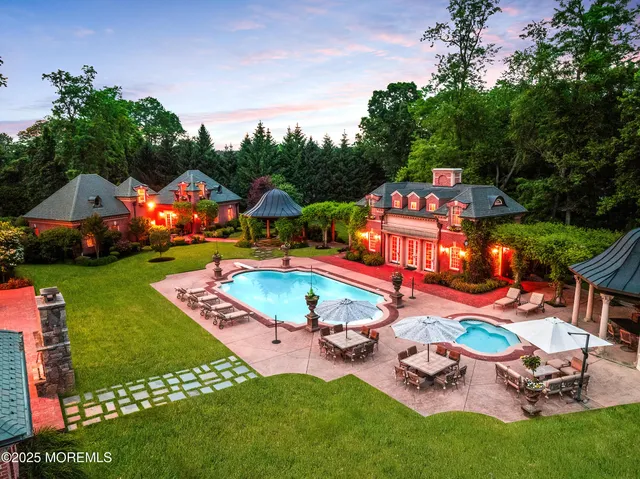 an aerial view of a chairs and table in backyard