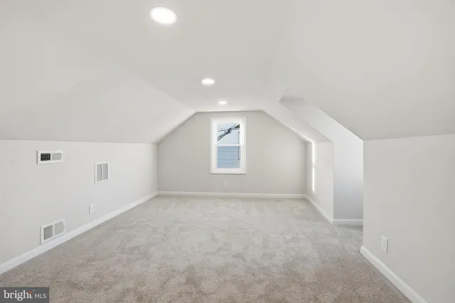 an empty room with a empty space and windows