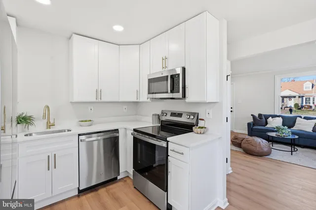 a kitchen with a refrigerator sink and cabinets