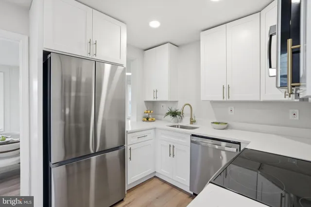 a living room with white cabinets and entryway