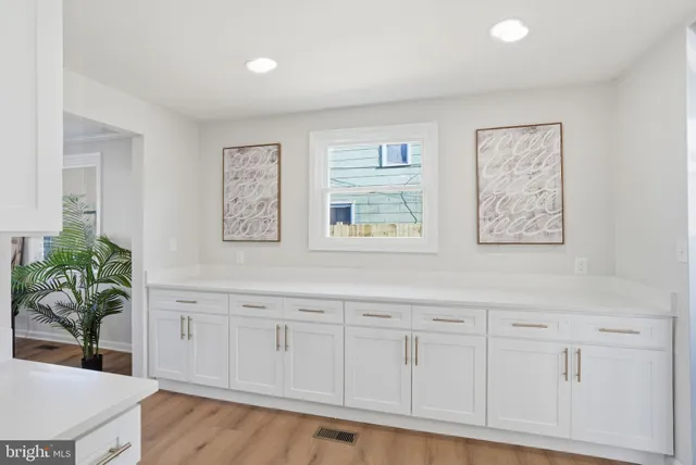 a living room with white cabinets and entryway