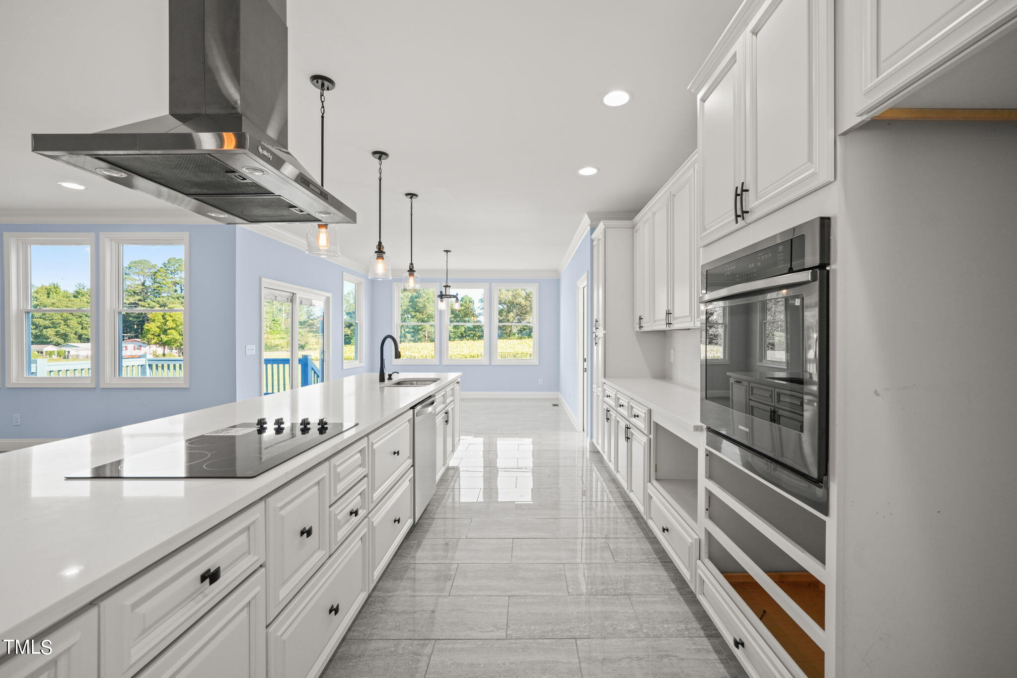 2804 Jack Mitchell Road Zebulon, NC 27597 - Photo 15 of 56 a large white kitchen with granite countertop a large window and stainless steel appliances