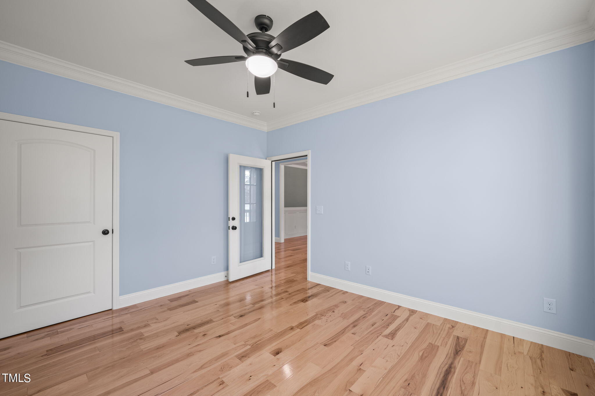 2804 Jack Mitchell Road Zebulon, NC 27597 - Photo 21 of 56 an empty room with wooden floor and ceiling fan