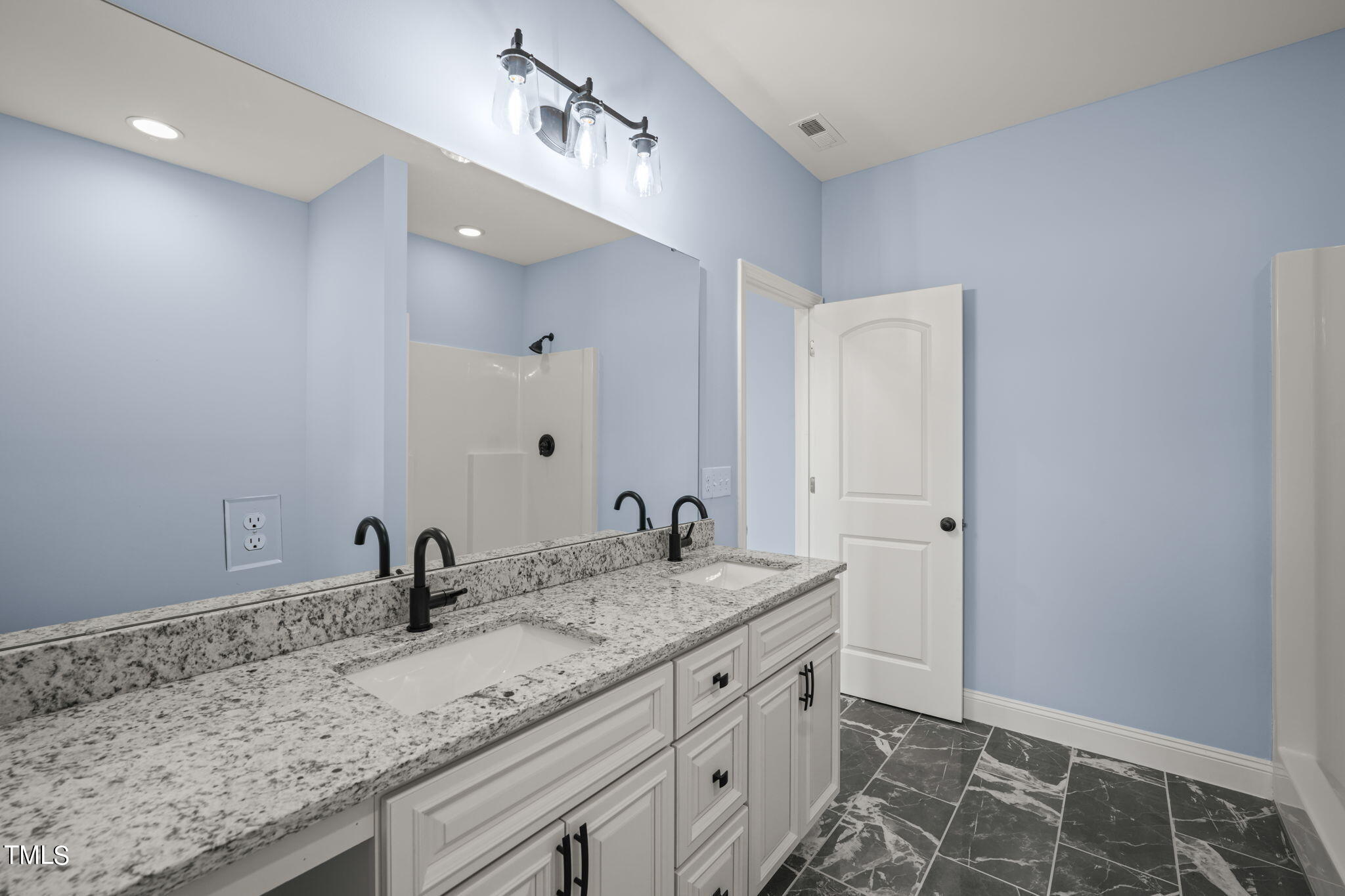 2804 Jack Mitchell Road Zebulon, NC 27597 - Photo 36 of 56 a bathroom with a granite countertop sink and a mirror