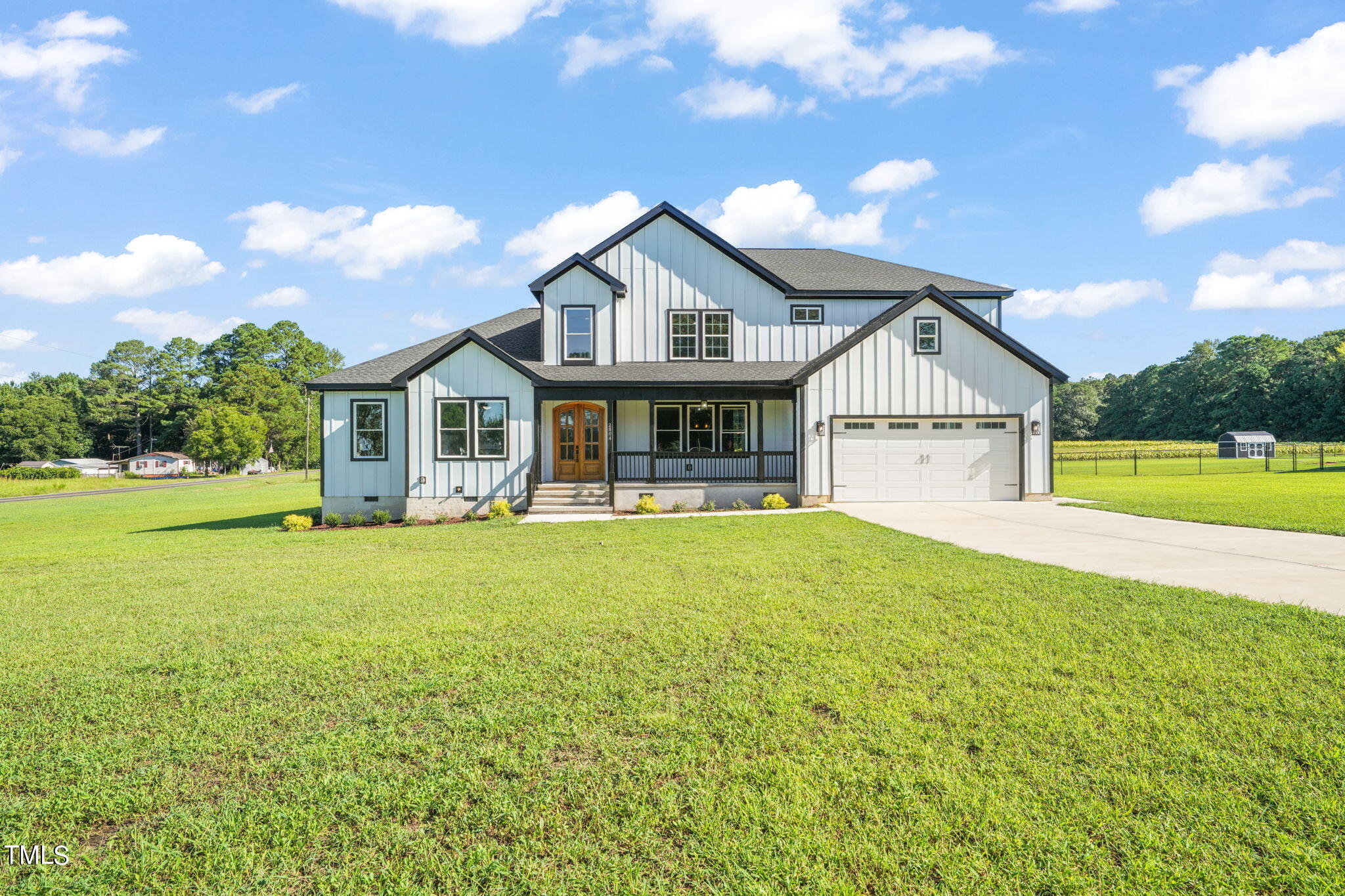 2804 Jack Mitchell Road Zebulon, NC 27597 - Photo 52 of 56 a view of a house with a yard and garage