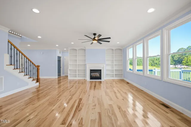 a view of a livingroom with a ceiling fan window and a fireplace