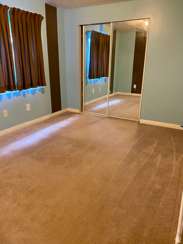 3918 Mapleleaf Way West Jordan, UT 84088 - Photo 5 of 12 Unfurnished bedroom with carpet floors and a closet
