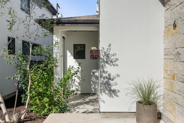 a view of a house with potted plants