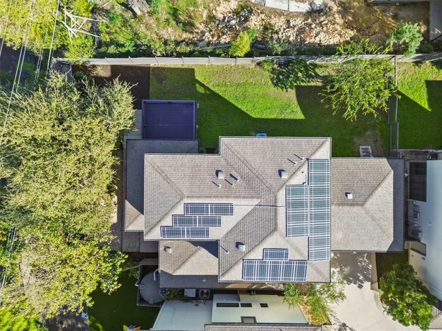 an aerial view of a house with a garden and plants