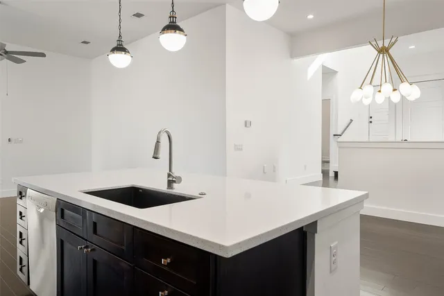 a kitchen with a sink a counter and a stove