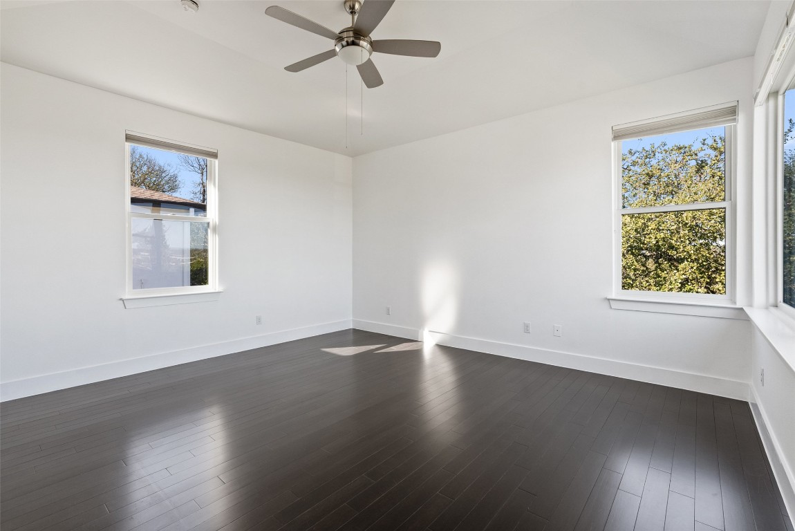 1303 Azie Morton Road, Unit 6 Austin, TX 78704 - Photo 25 of 40 a view of an empty room with wooden floor and a window