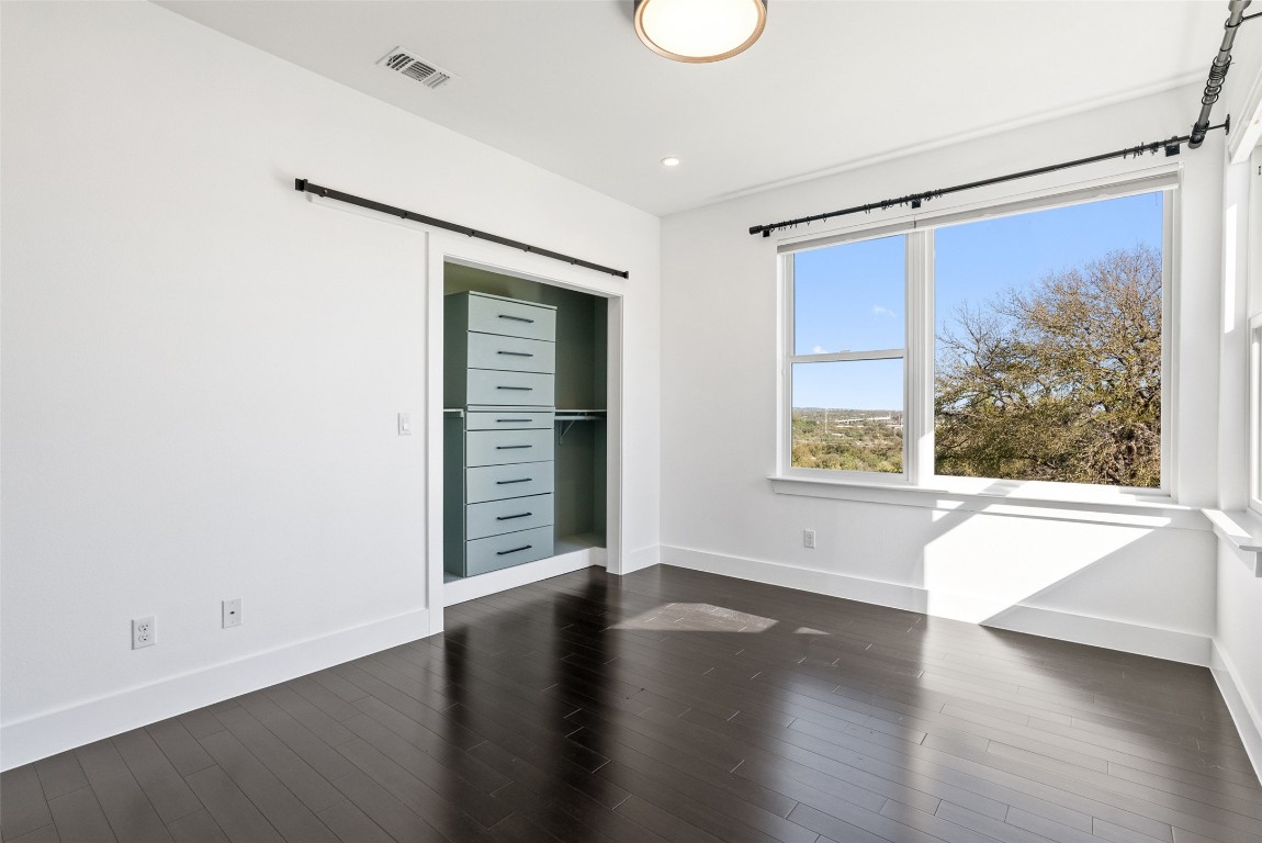 1303 Azie Morton Road, Unit 6 Austin, TX 78704 - Photo 28 of 40 an empty room with wooden floor and windows