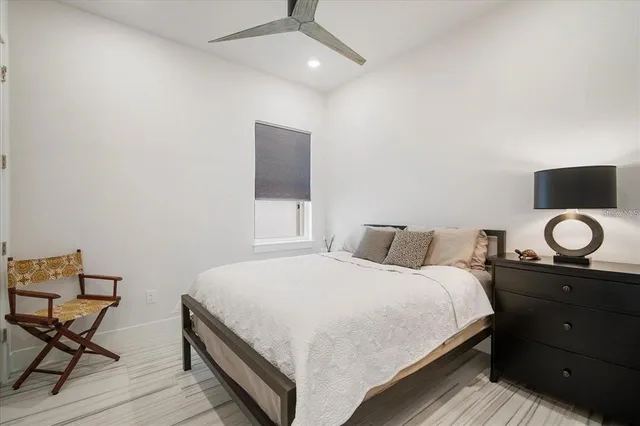 a bedroom with a bed and with furniture