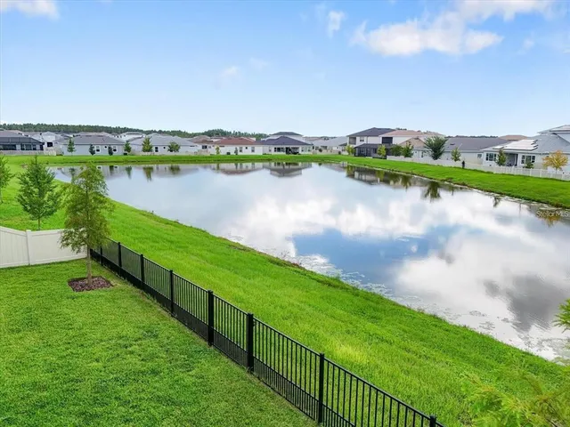 a view of a lake with houses in the back