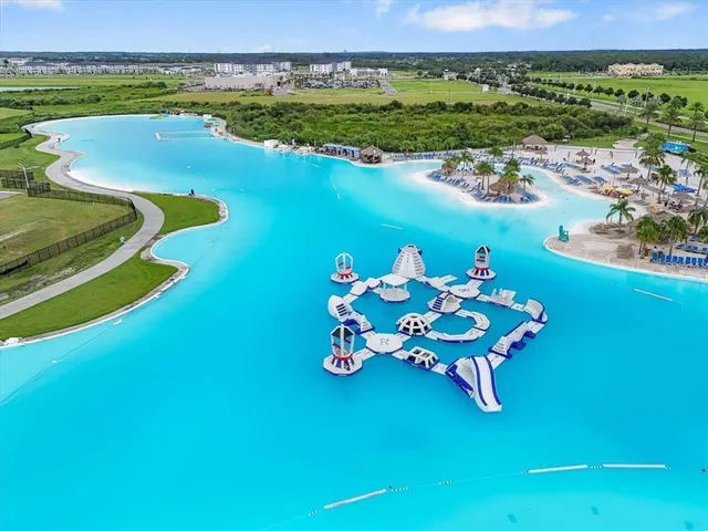 an aerial view of a golf course with pool an ocean view
