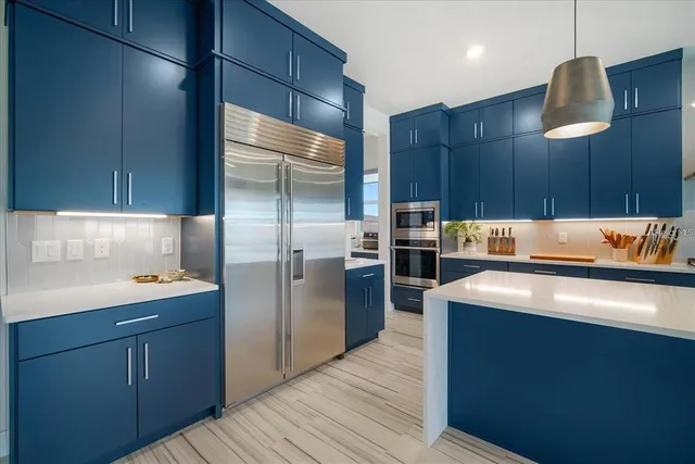 a kitchen with stainless steel appliances a refrigerator and a sink