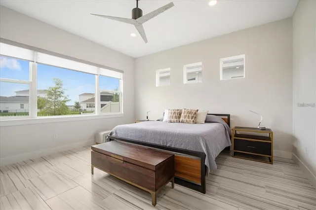 a bedroom with bed and wooden floor