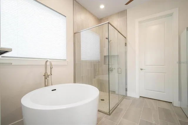 a bathroom with a white bath tub and shower