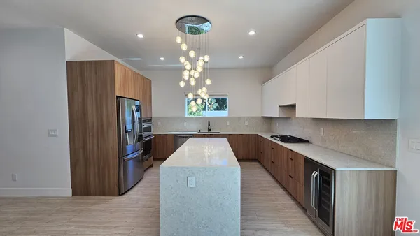 a kitchen with stainless steel appliances granite countertop a stove and a refrigerator