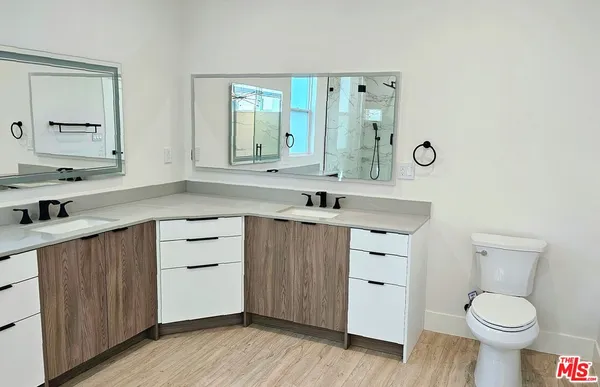 a bathroom with a sink toilet a mirror and vanity