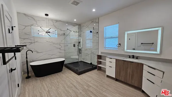 a spacious bathroom with double vanity and a bathtub