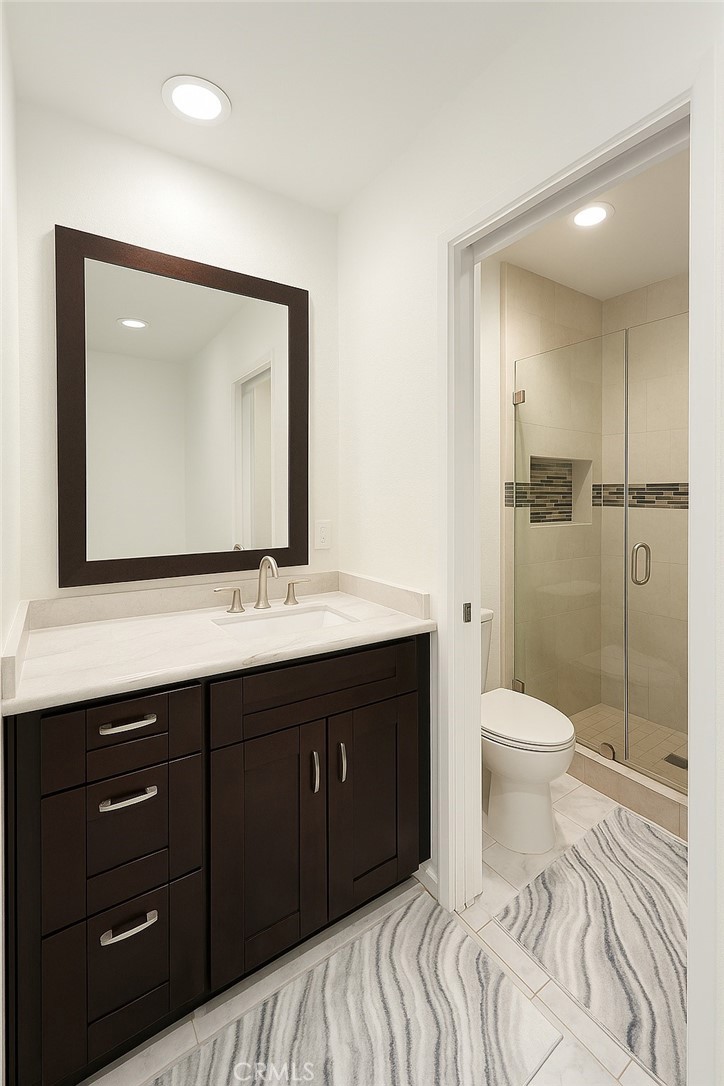 24612 Harbor View Drive, Unit 55C Dana Point, CA 92629 - Photo 11 of 17 a bathroom with a toilet a sink and mirror