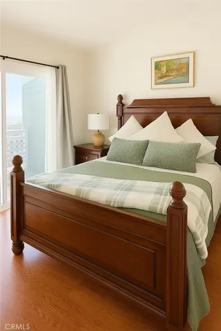 a bedroom with a bed and a mirror