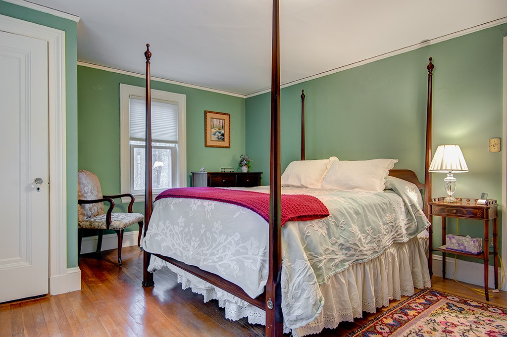 61 Silver Hill Road Weston, MA 02493 - Photo 13 of 18 a bedroom with a bed table and a lamp