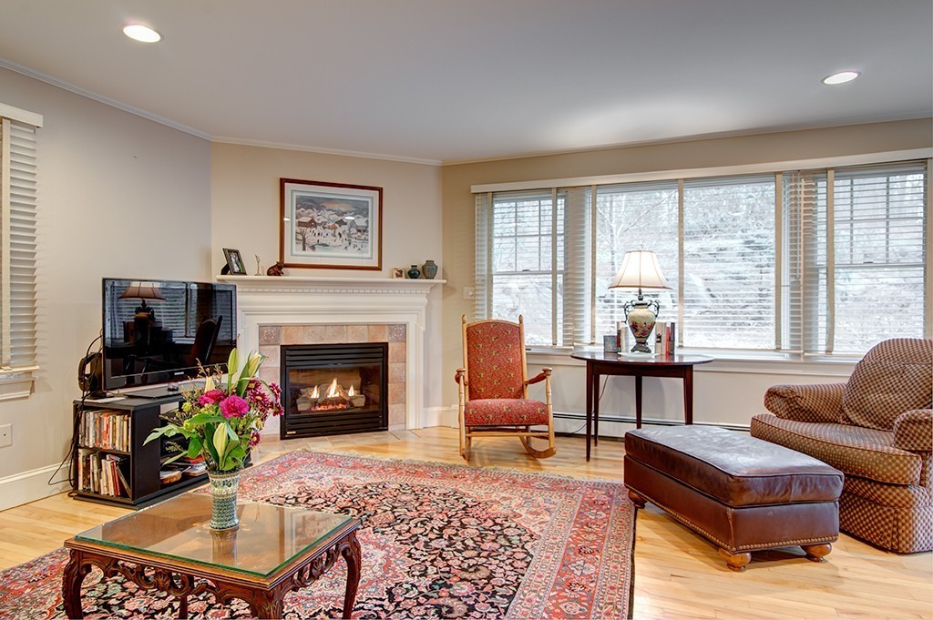 61 Silver Hill Road Weston, MA 02493 - Photo 7 of 18 a living room with furniture a flat screen tv and a fireplace