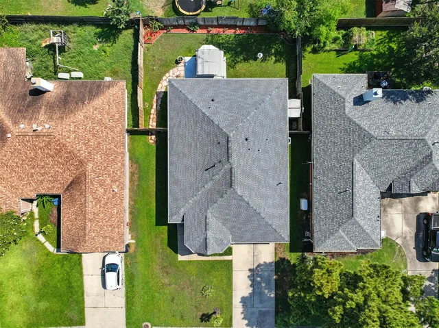 an aerial view of a house with a yard basket ball court and outdoor seating