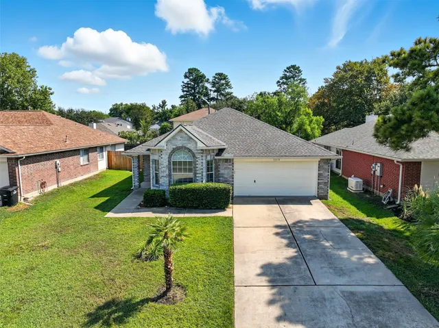 a front view of house with yard and green space