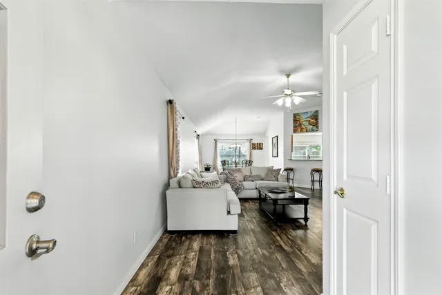 a living room with furniture a flat screen tv and a table