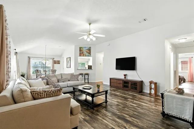 a living room with furniture chandelier and a window