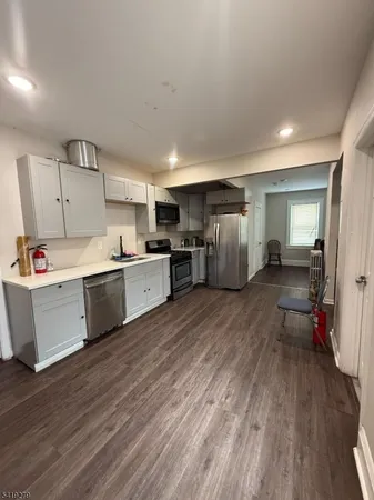 a living room with furniture a dining table and a window