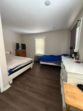 a living room with furniture and a computer on desk