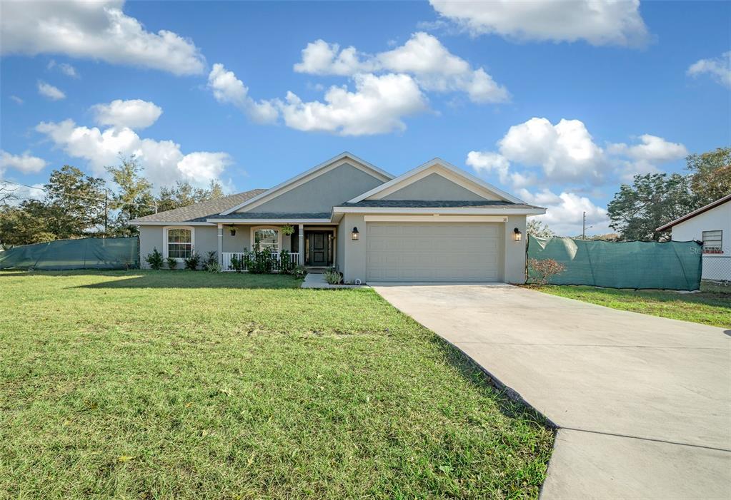 38 Spring Track Ocala, FL 34472 - Photo 1 of 1 a front view of a house with a garden and yard