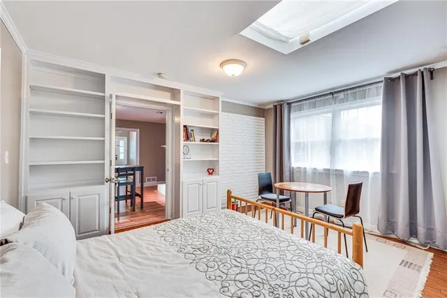 a bedroom with furniture and a large window