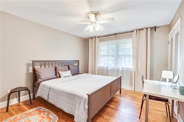 a bedroom with a large bed and a chandelier