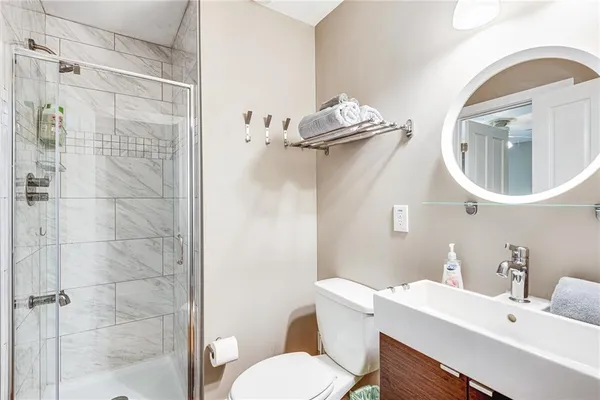 a bathroom with a toilet a sink and mirror