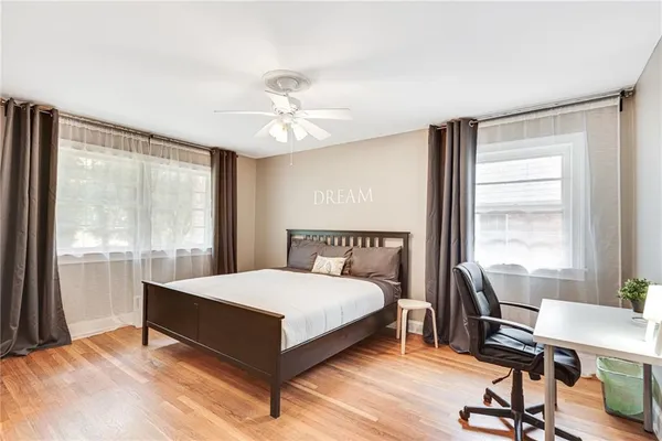 a spacious bedroom with a bed and a window