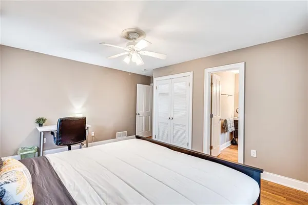 a bedroom with a bed and chair