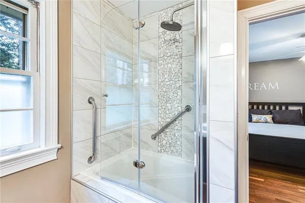 a bathroom with a shower and a sink